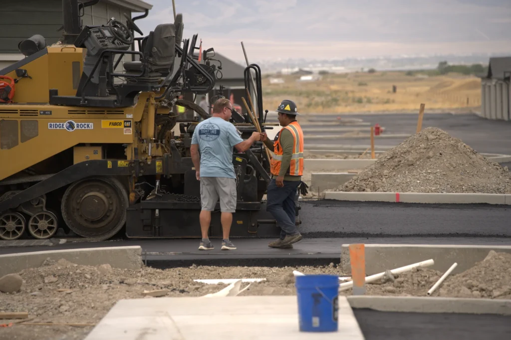 Two Workers By Paver