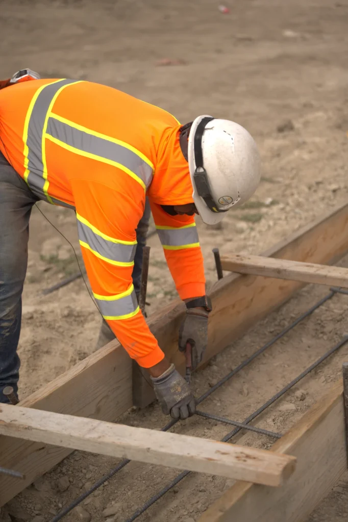 Worker Tying Rebar Grid